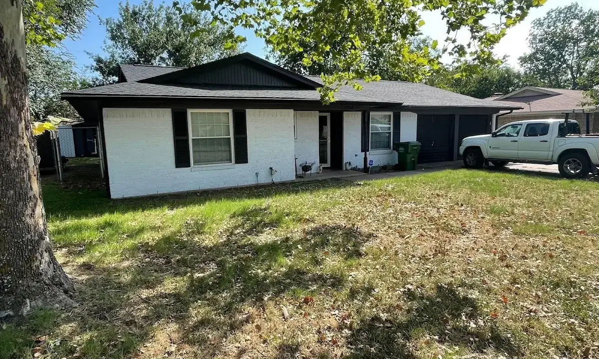 Professional roofing crew working on a residential roof in Bettendorf